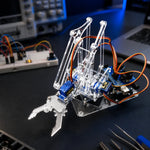 4DOF laser-cut acrylic robotic arm frame with mounted micro servos and control board on an electronics workbench