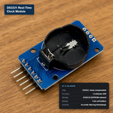 DS32321 Real-Time Clock Module on a wooden surface, featuring a blue PCB with a black RTC battery holder and silver pins, with text overlays detailing specifications.