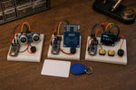 Example builds from the ESP32 Builder Kit: a distance warning system, an RFID access demo and a reaction timer game (illustrative image)