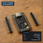 ESP32-C3 SuperMini development board with two loose pin header strips, showing its single-core RISC-V chip, Wi-Fi 4 + Bluetooth 5, ~11-13 usable GPIO pins, and USB-C connector.