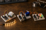 Example builds from the ESP32 Beginner Kit: a motion-activated desk light, a servo position controller and electronic dice (illustrative image)