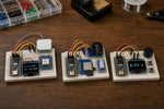 Example builds from the ESP32 Beginner Kit: a GPS location display, an SD card data logger and a reaction timer game (illustrative image)