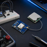 NEO-6M GPS module with ceramic patch antenna connected via coax cable, set up on an electronics workbench with a breadboard and multimeter