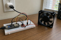 Breadboard power current monitor with INA219 sensor wired to a small DC cooling fan