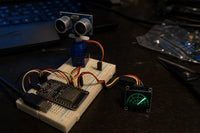 HC-SR04 ultrasonic sensor on a servo sweeping next to a small OLED radar display