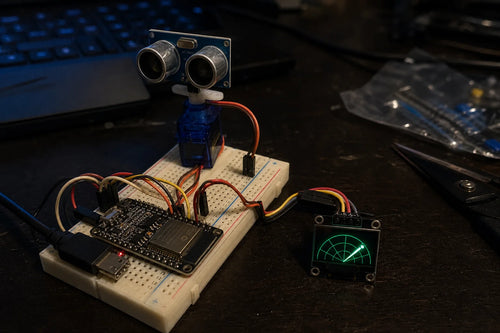 HC-SR04 ultrasonic sensor on a servo sweeping next to a small OLED radar display