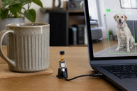 Seeed XIAO ESP32S3 Sense tiny board with camera, connected to laptop showing live object detection of a dog