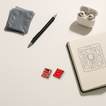 TTP223 capacitive touch sensor modules on a bright minimal desk beside a notebook with circuit sketches